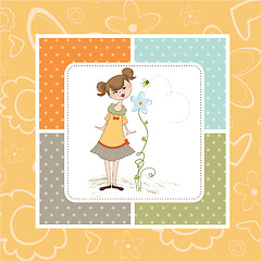 Image showing small young lady who smells a flower