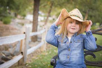 Image showing Cute Young Girl Wearing Cowboy Hat Posing for Portrait Outside