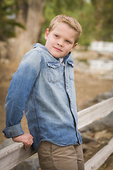 Image showing Handsome Young Boy Against Fence in Park