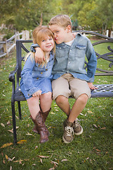 Image showing Happy Young Brother and Sister Sitting Together Outside
