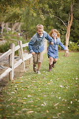 Image showing Happy Young Brother and Sister Running Outside