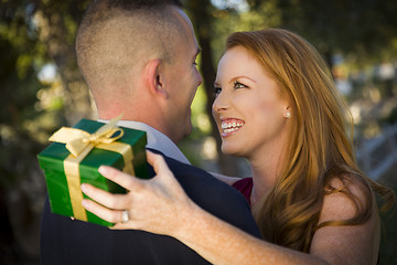 Image showing Beautiful Woman and Handsome Military Man Exchange Christmas Gif