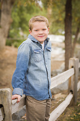 Image showing Handsome Young Boy Against Fence in Park