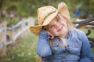 Image showing Cute Young Girl Wearing Cowboy Hat Posing for Portrait Outside
