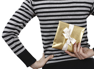 Image showing Young woman holding a present