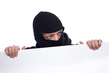 Image showing Robber hiding behind a empty white  space for text
