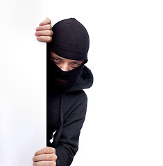 Image showing Robber hiding behind a empty white  space for text
