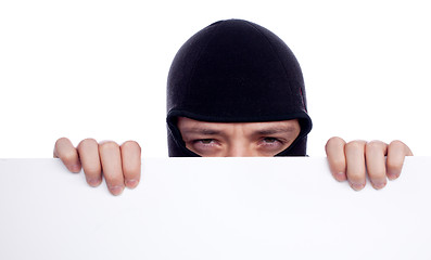 Image showing Robber hiding behind a empty white  space for text