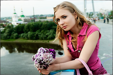 Image showing Pretty woman holding a bouquet