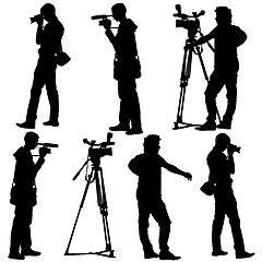 Image showing Cameraman with video camera. Silhouettes on white background. Ve