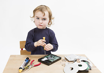 Image showing child repairing computer part