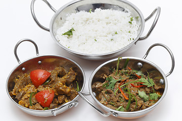 Image showing Lamb curries and rice s3erving bowls