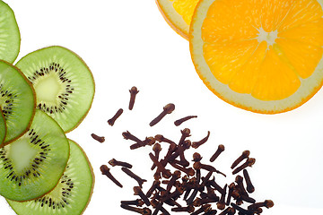 Image showing sliced kiwi fruit and orange with clove
