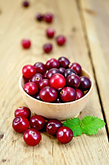 Image showing Cranberries in a wooden bowl on the board