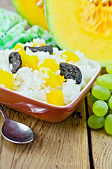 Image showing Rice with pumpkin and prunes on the board