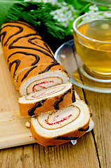 Image showing Roulade with a cup of tea on board