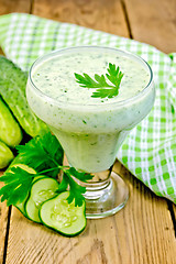 Image showing Yoghurt with cucumber and parsley on the board