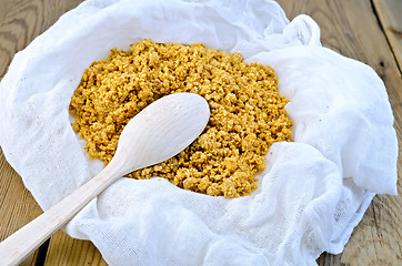 Image showing Curd red in gauze with spoon