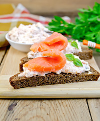 Image showing Sandwiches on bread with salmon on board