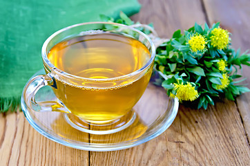 Image showing Herbal tea with a bouquet of Rhodiola rosea on the board