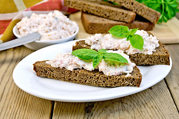 Image showing Sandwiches with cream of salmon and mayonnaise on the board