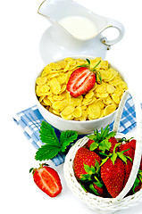 Image showing Cornflakes with milk in a jug and strawberries