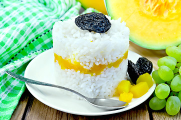 Image showing Rice with pumpkin and grapes on the board