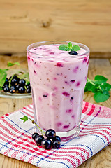 Image showing Milk cocktail with black currants on the board