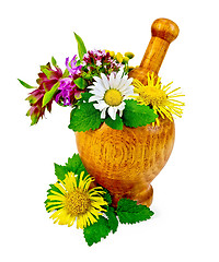 Image showing Herbs and flowers in a mortar and table