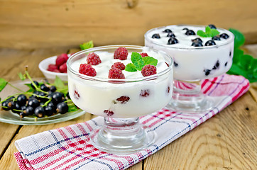Image showing Yogurt thick with black currant and raspberry on the board