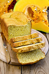 Image showing Bread homemade pumpkin on a board with a knife