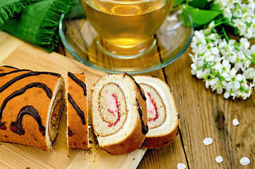 Image showing Roulade with cream and jam on the board