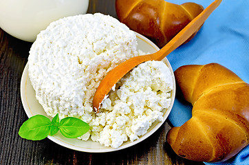 Image showing Curd with a wooden spoon and bagel on the board