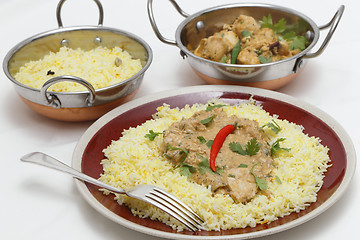 Image showing Pasanda chicken meal with serving bowls