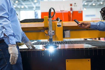 Image showing Machine cutting steel in a factory