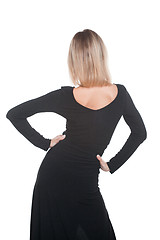 Image showing Trendy blonde woman in black dress standing back