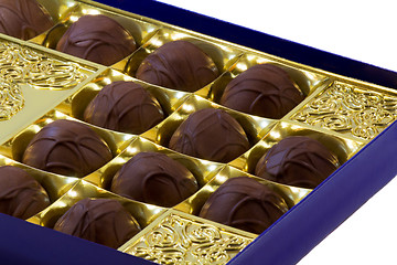 Image showing Chocolate sweets in the box on the white background.