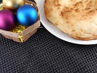 Image showing christmas cake on white plate and christmas baubles