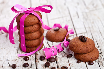 Image showing stack of chocolate cookies tied with pink ribbon and coffee bean