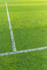 Image showing White line on the green turf for football court