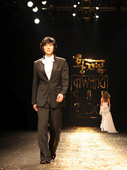 Image showing Asian male model on the catwalk during a fashion show - EDITORIA