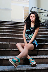 Image showing beautiful young girl sitting on stairs