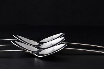 Image showing Spoons on a black table