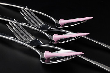 Image showing Forks and spoons on a black table