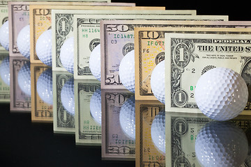 Image showing Golf balls and US dollars banknotes