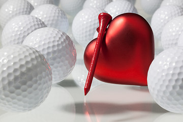 Image showing Many golf balls and red heart 