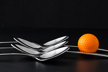 Image showing Spoons and golf balls 