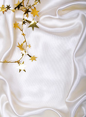 Image showing Golden stars and spangles on white silk