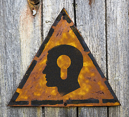 Image showing Head with a Keyhole Icon on Rusty Warning Sign.