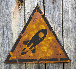 Image showing Icon of Go Up Rocket on Rusty Warning Sign.